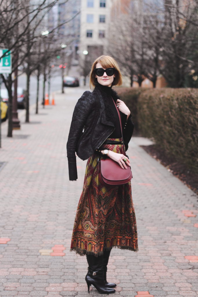 black turtleneck, leather jacket, and vintage brown skirt