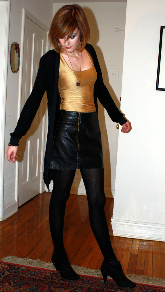 gold tank top and leather skirt