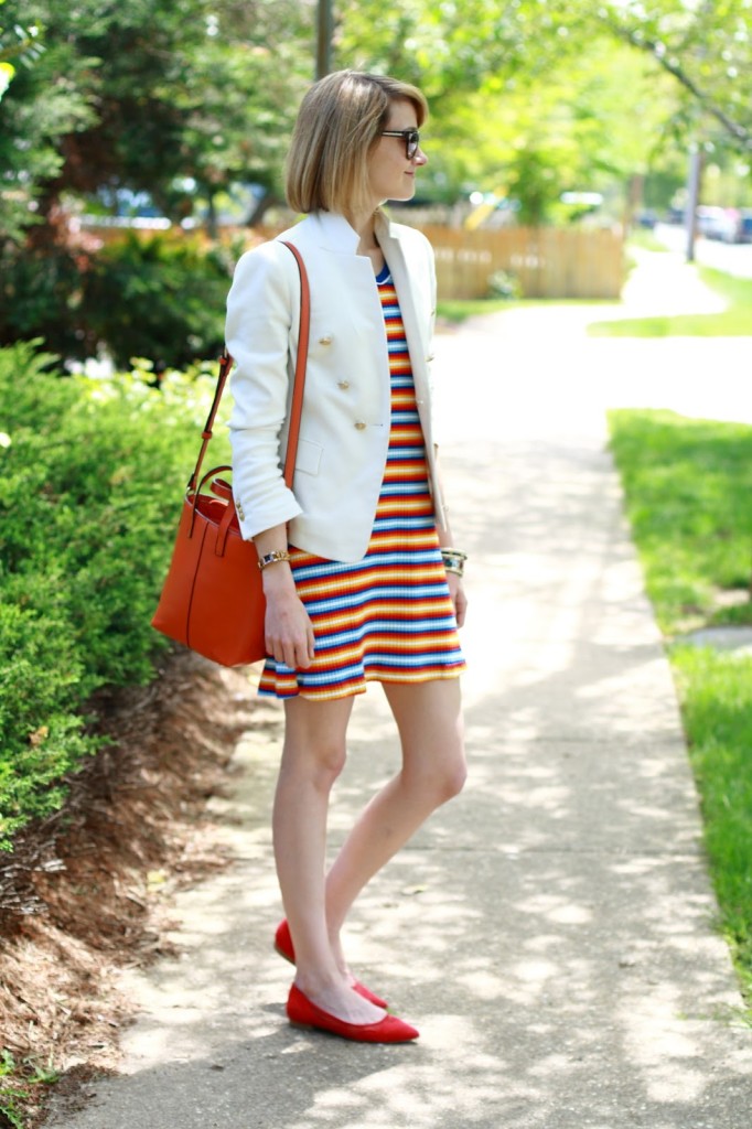 white blazer, orange bag, and striped dress