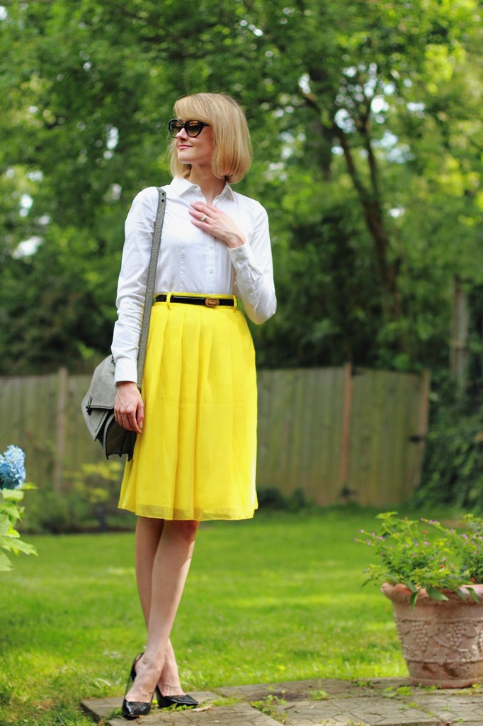 white button-down and yellow skirt