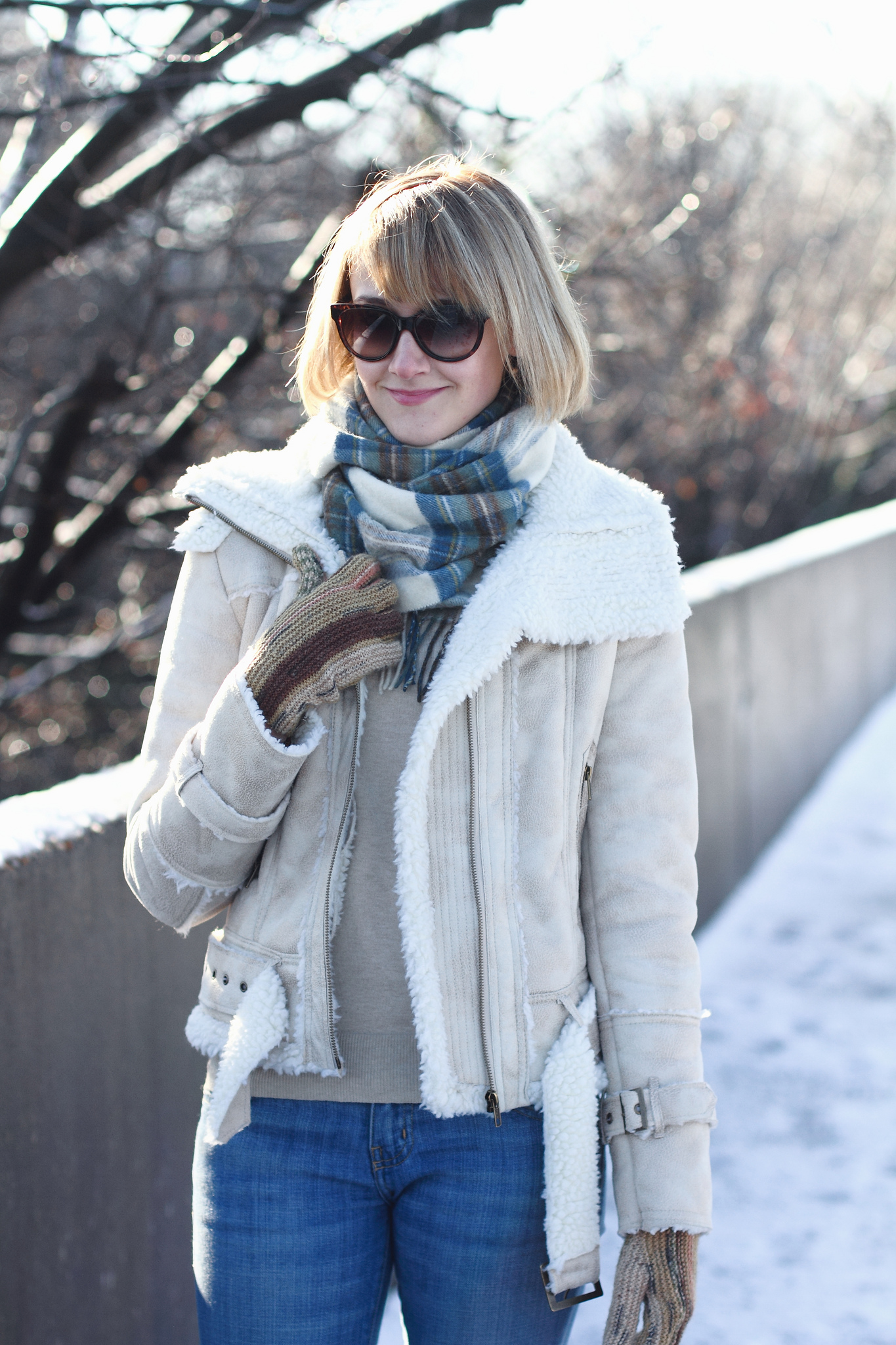 white shearling jacket and brown knee-high boots