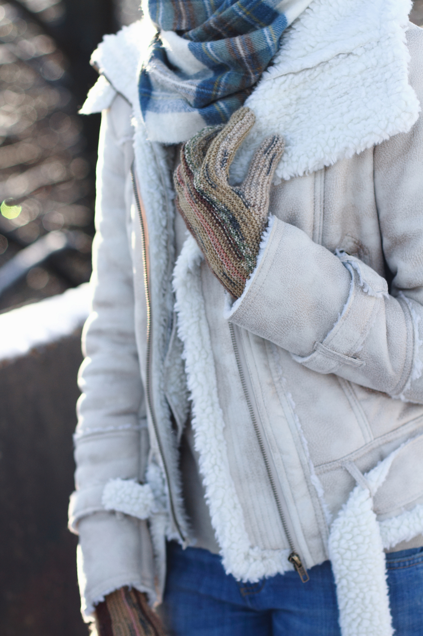 white shearling jacket and brown knee-high boots