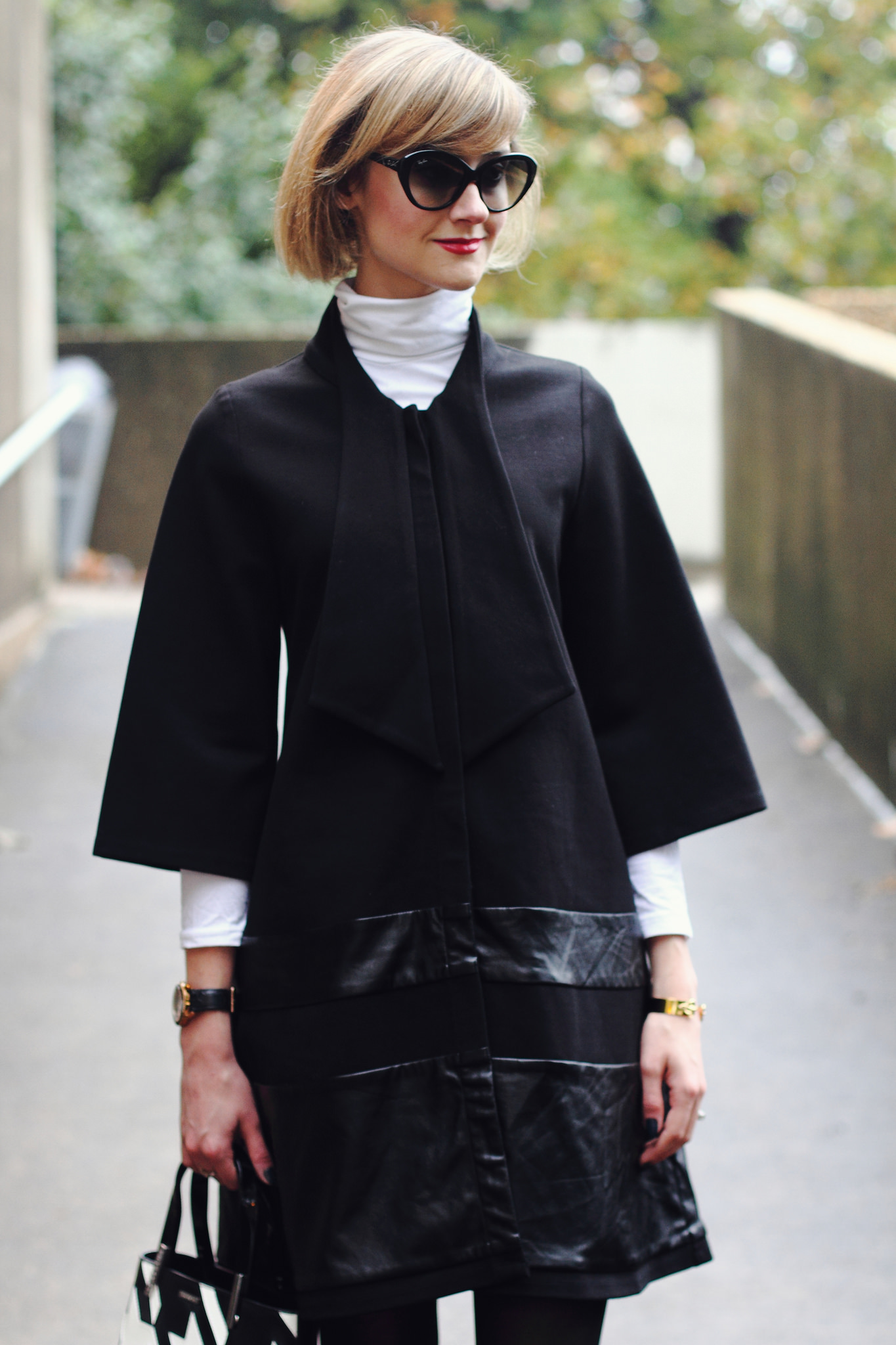 white turtleneck and black tie coat