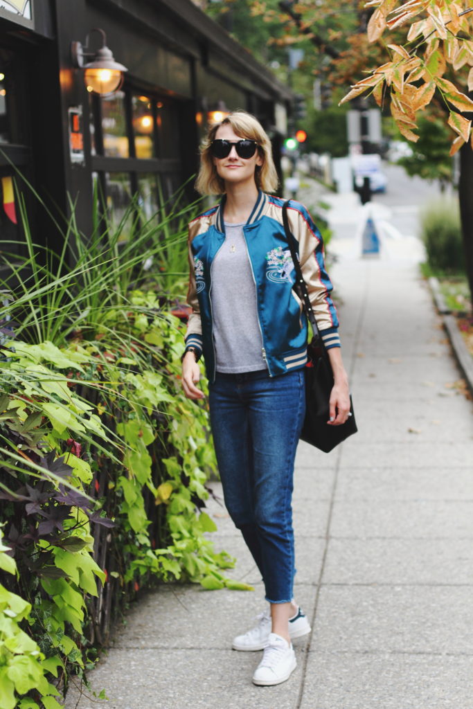 satin bomber, cropped jeans, and Stan Smiths