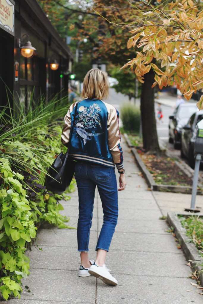 satin bomber, cropped jeans, and Stan Smiths