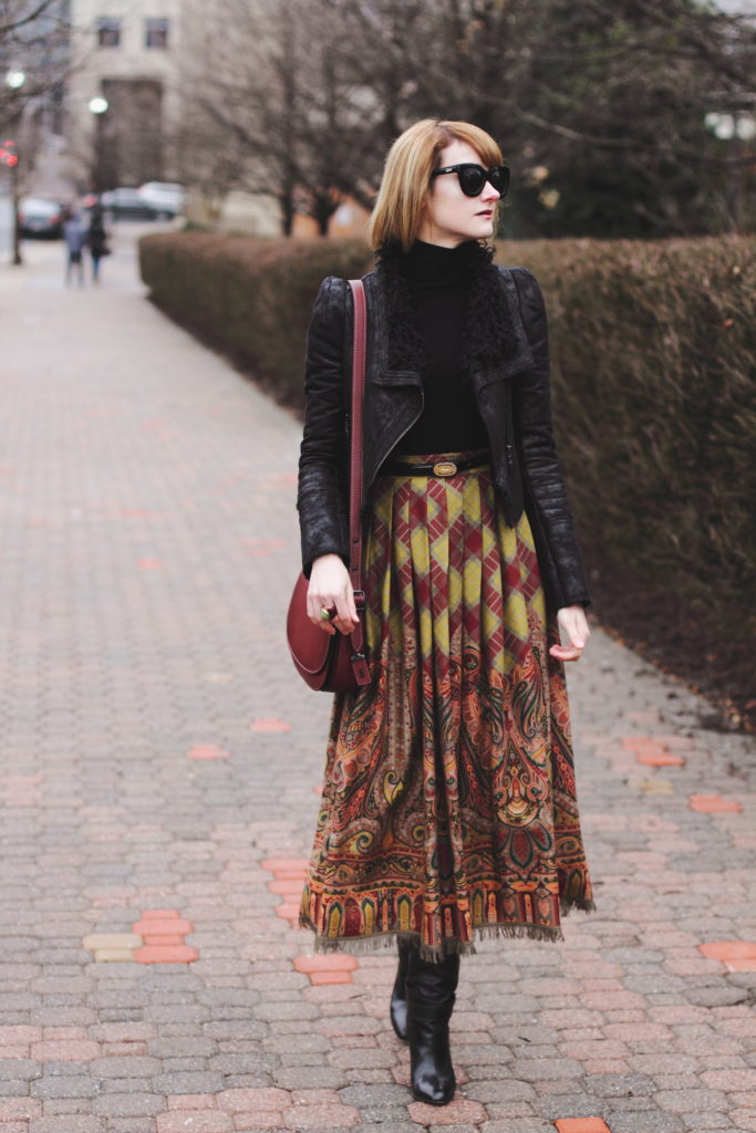 black turtleneck, leather jacket, and vintage brown skirt