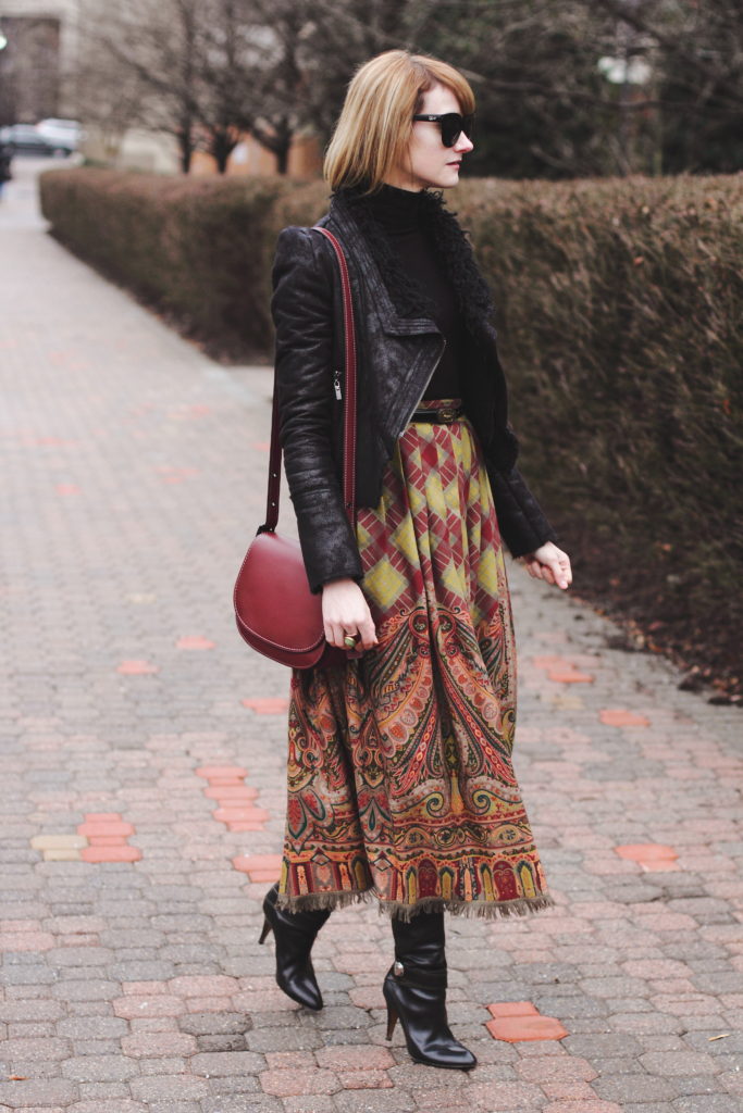 black turtleneck, leather jacket, and vintage brown skirt