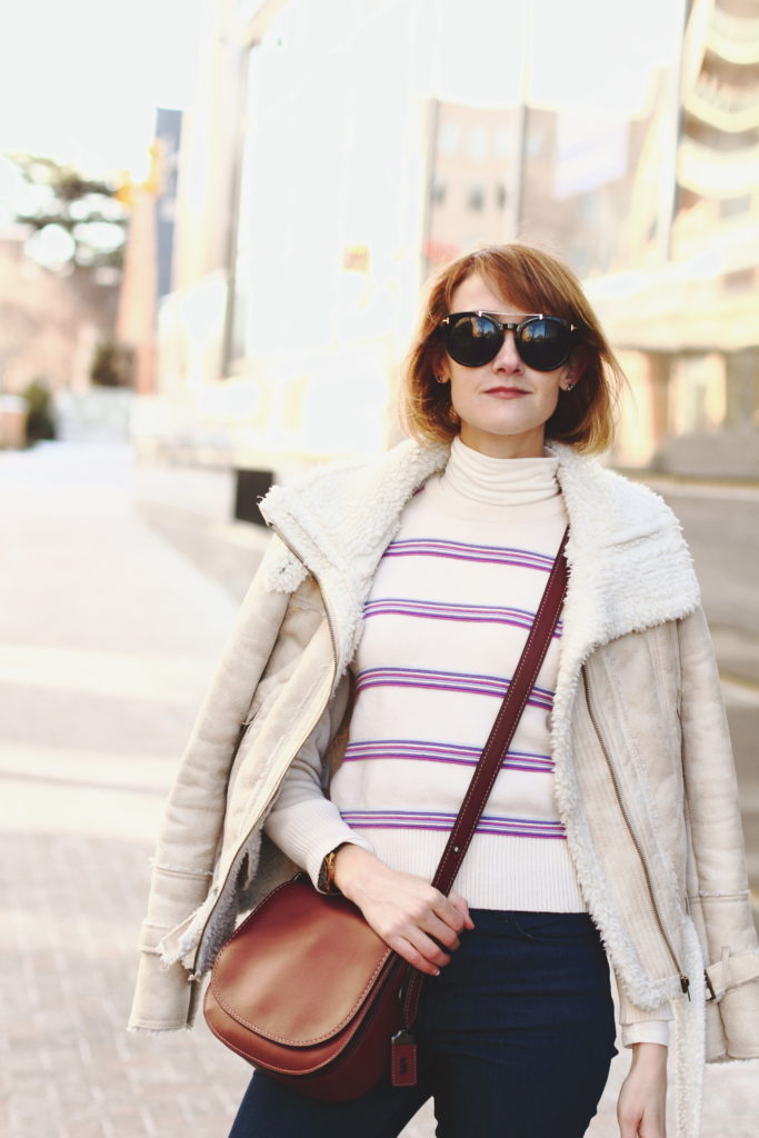 vintage ski sweater, shearling jacket, and Coach bag