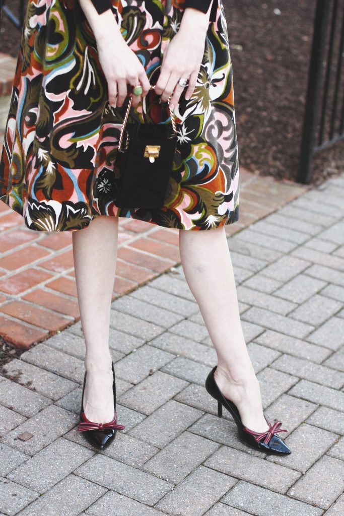 vintage evening bag, print skirt, and Prada pumps