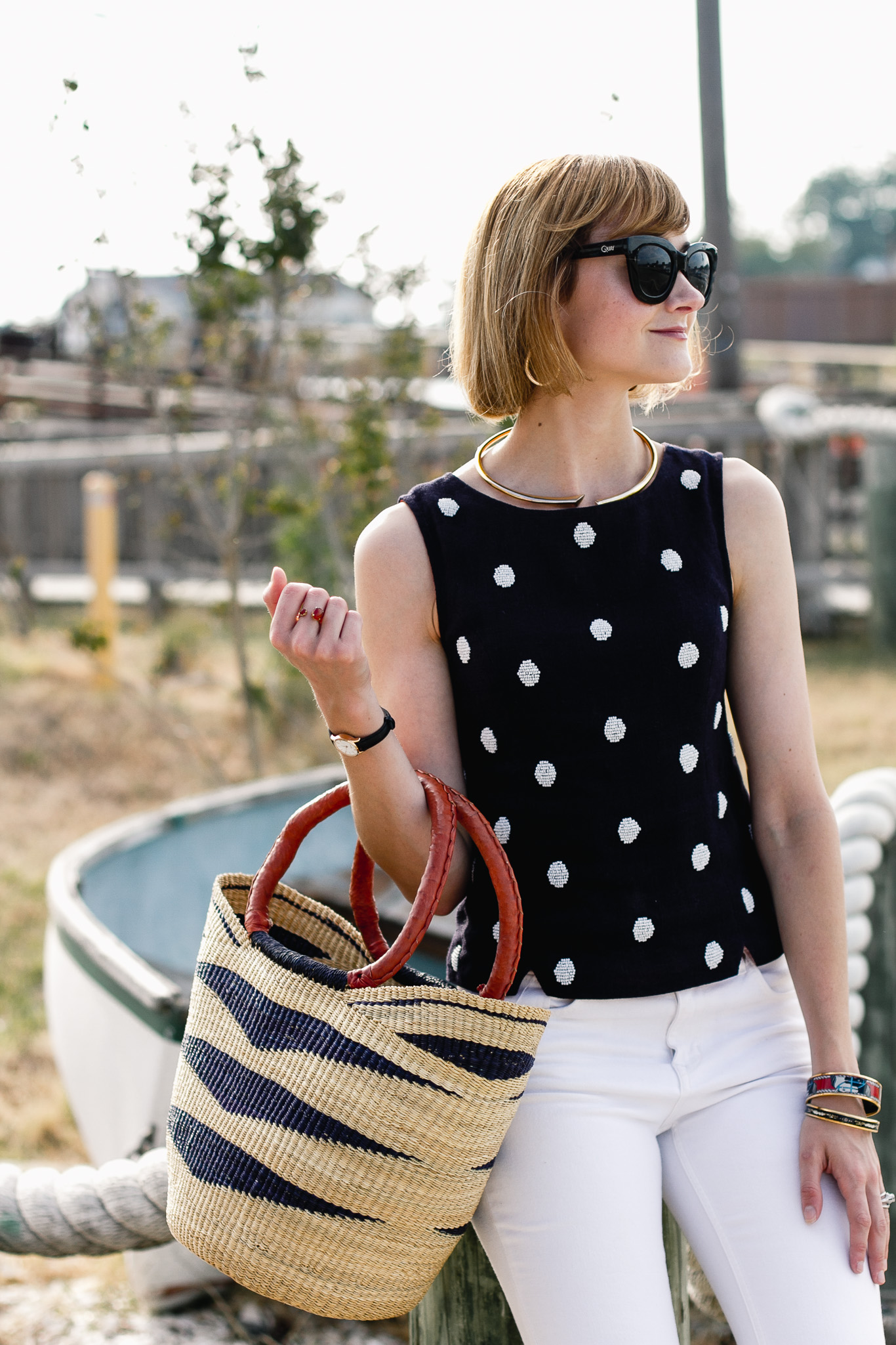 polka dot top, white denim, and straw bag