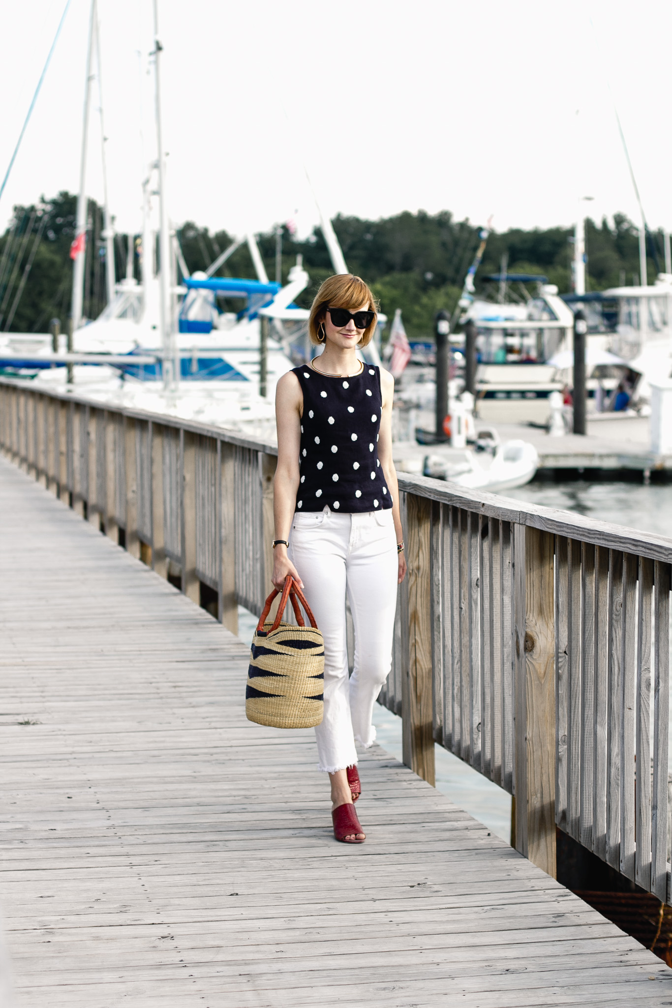polka dot top, white denim, and red mules