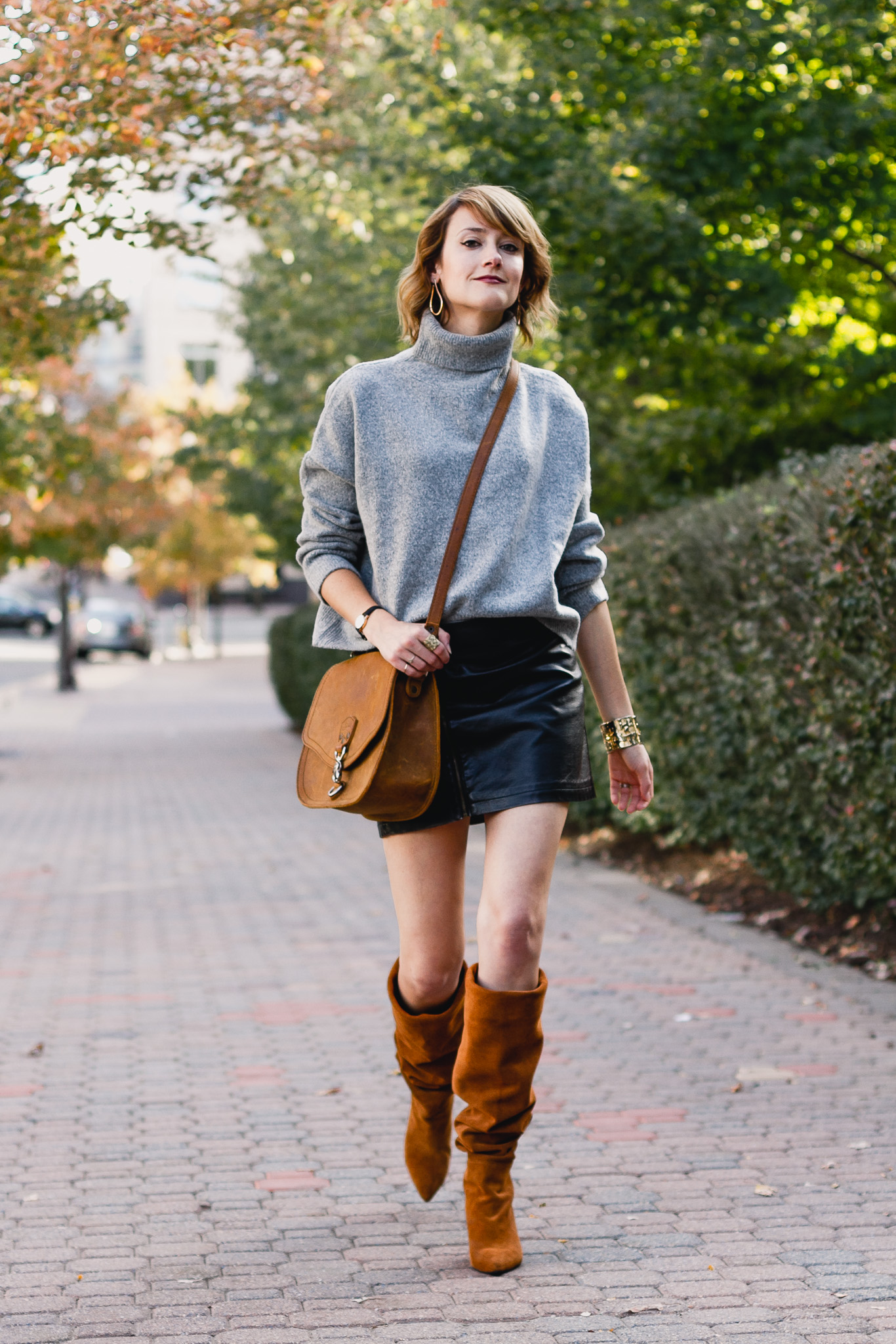 oversized sweater, leather skirt, and slouchy brown boots