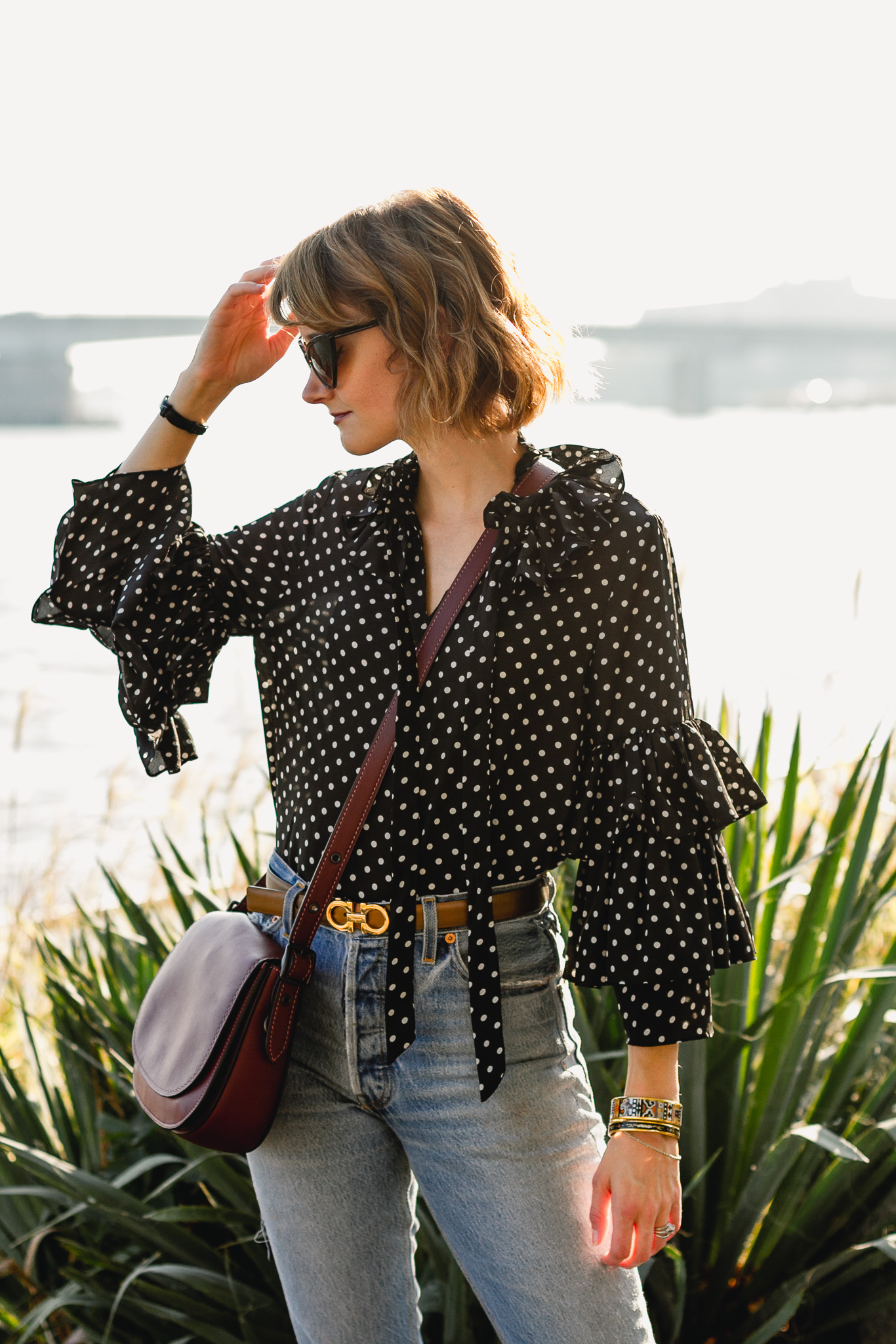 ruffled polka dot top, Ferragamo belt, and Coach bag