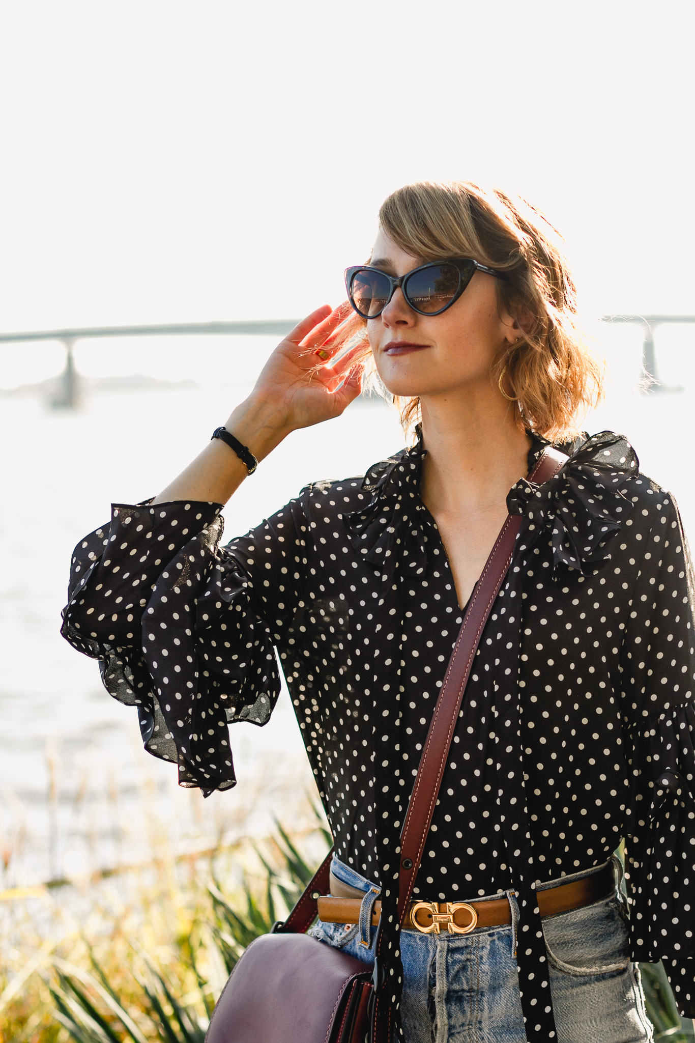 ruffled polka dot top, Ferragamo belt, and Coach bag