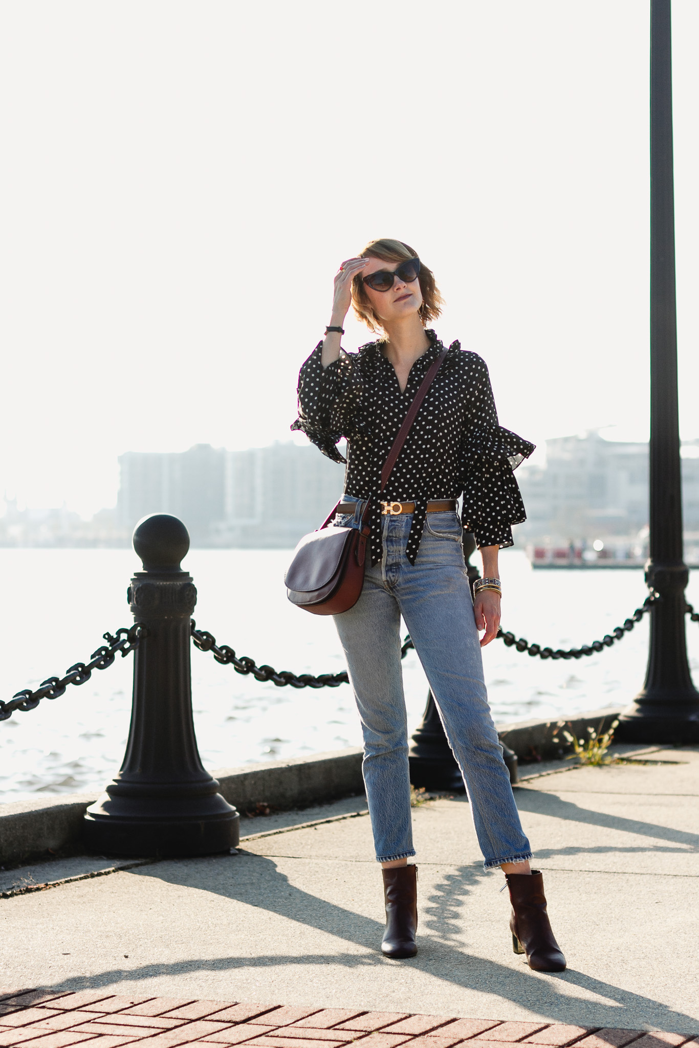 ruffled polka dot top, Ferragamo belt, and Re/Done jeans