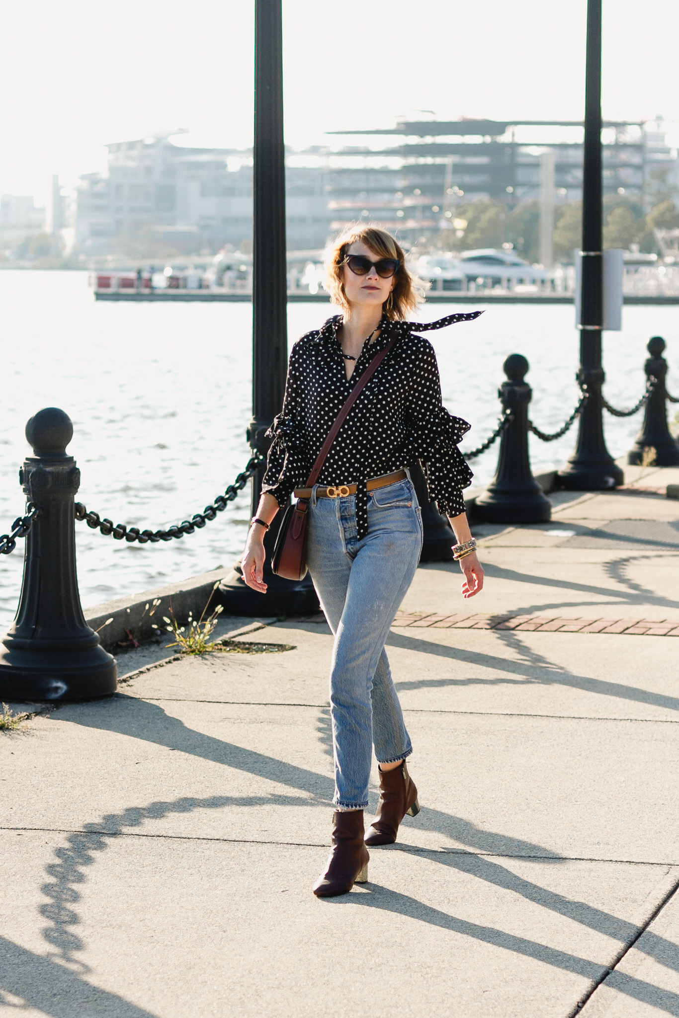 ruffled polka dot top, Ferragamo belt, and Re/Done jeans