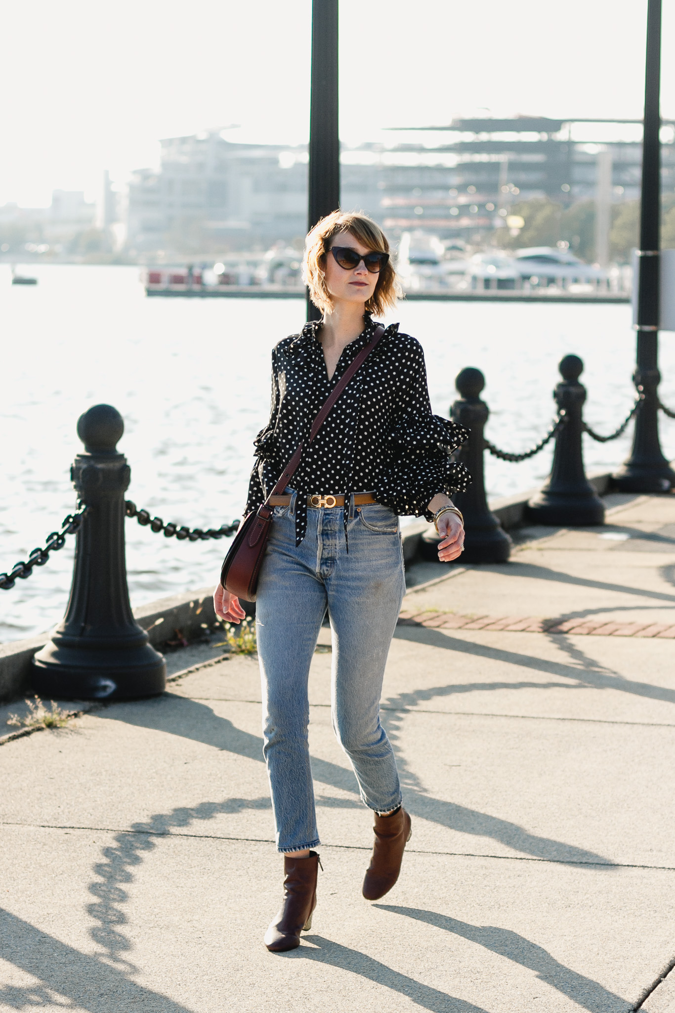 ruffled polka dot top, Ferragamo belt, and Re/Done jeans