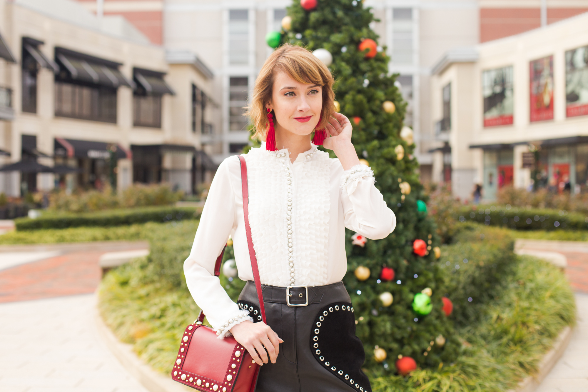 Alice + Olivia pearl-embellished blouse, Maje leather skirt, and Sandro bag