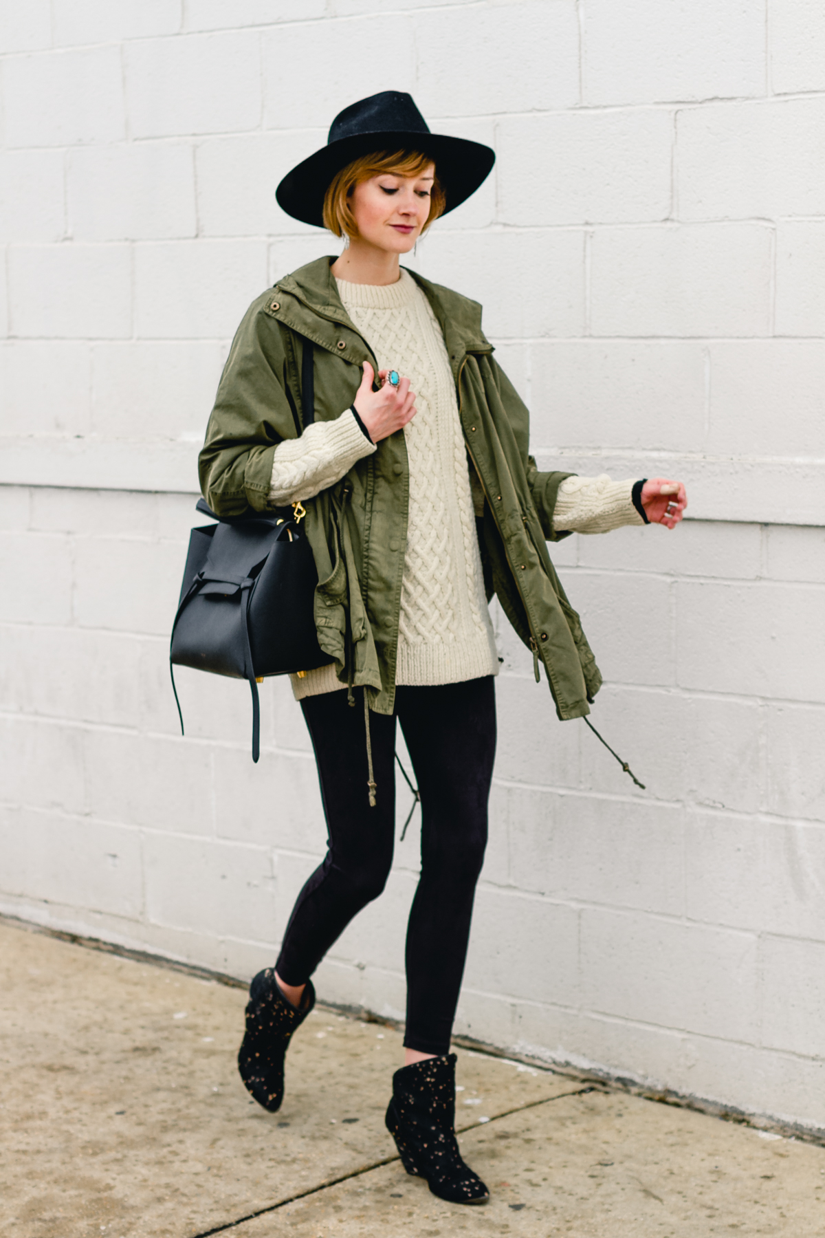 layered anorak, fisherman's knit, and suede leggings