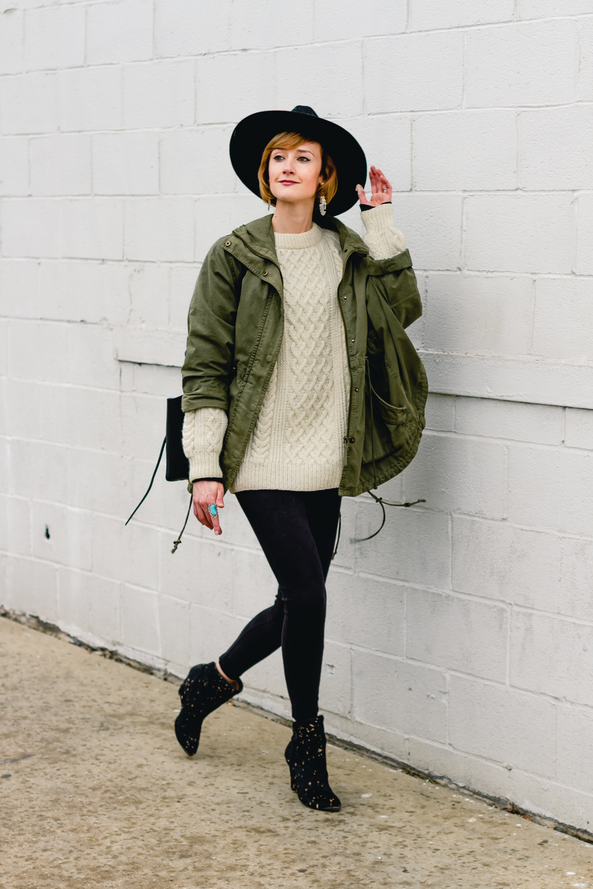 layered anorak, fisherman's knit, and suede leggings