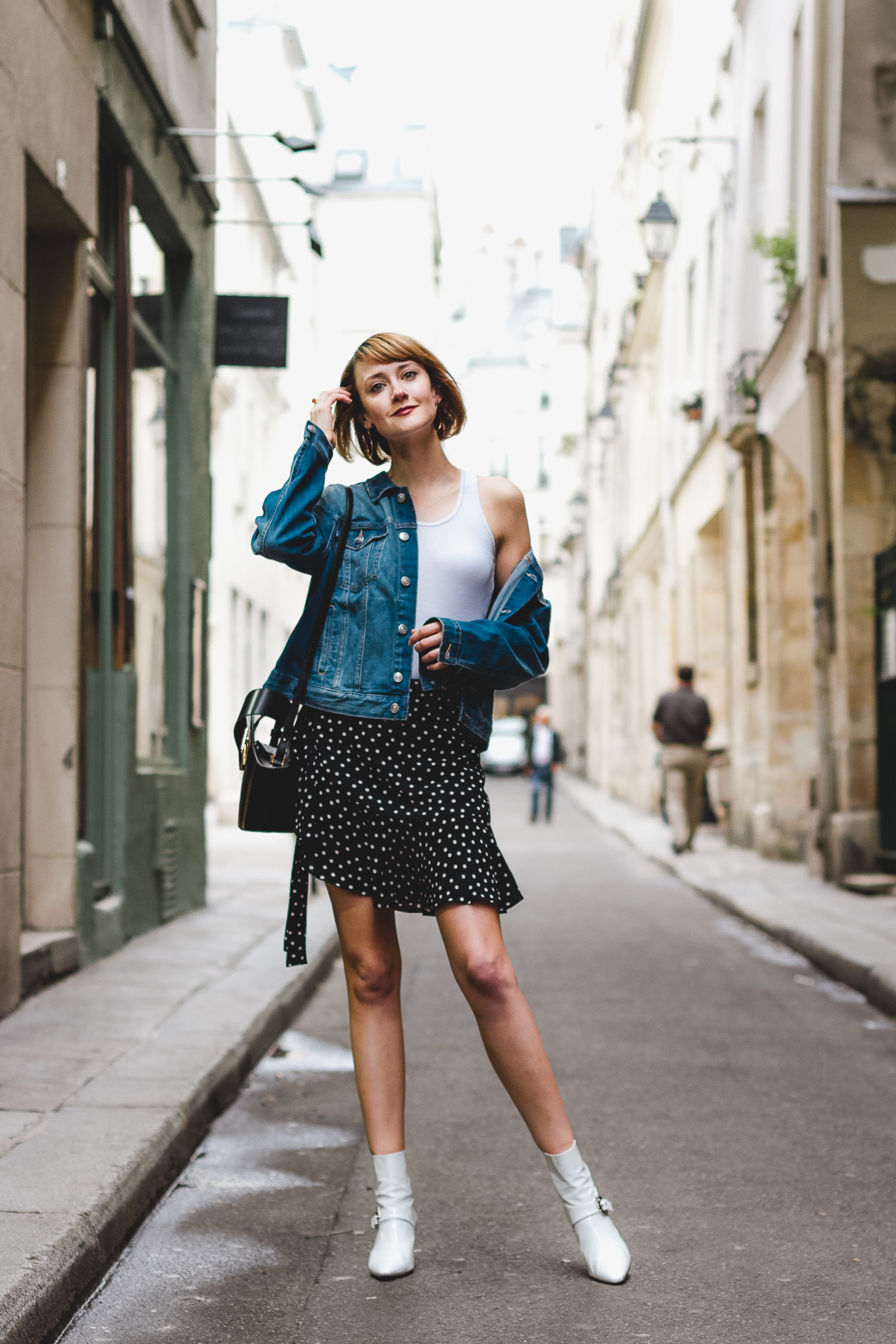 denim jacket, polka dot skirt, and white ankle boots