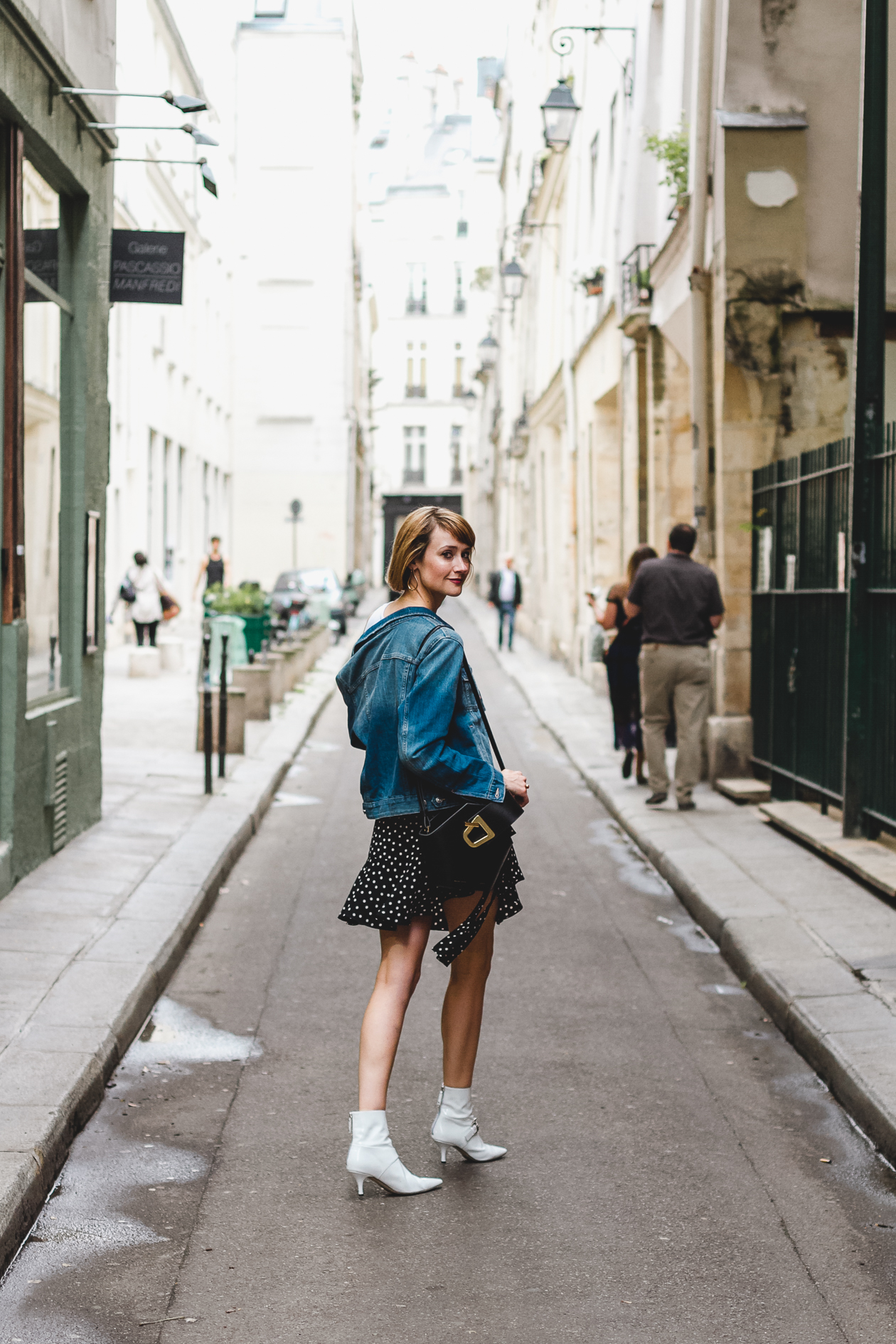 denim jacket, polka dot skirt, and white ankle boots