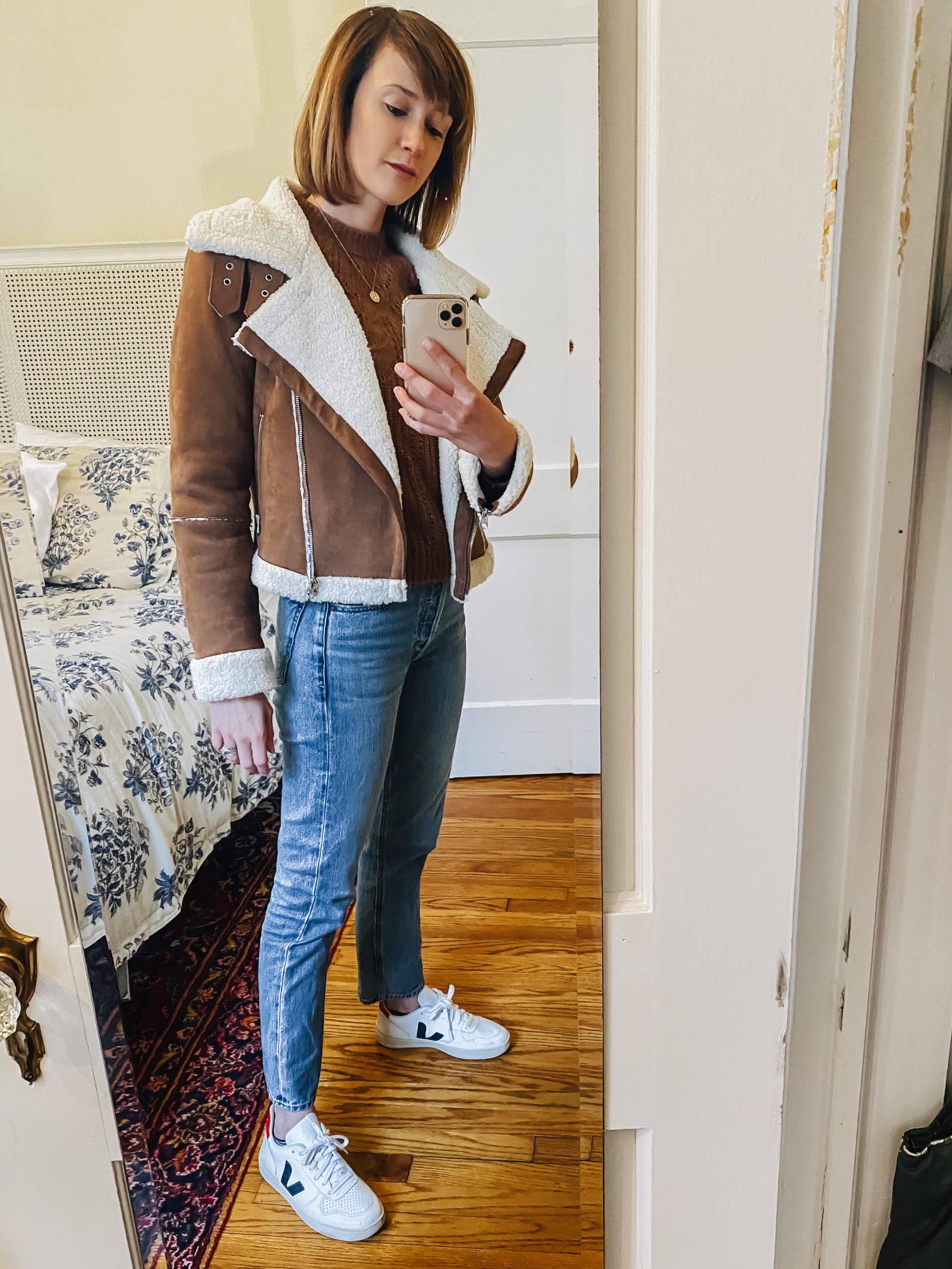 leather jacket, jeans, and Veja sneakers outfit